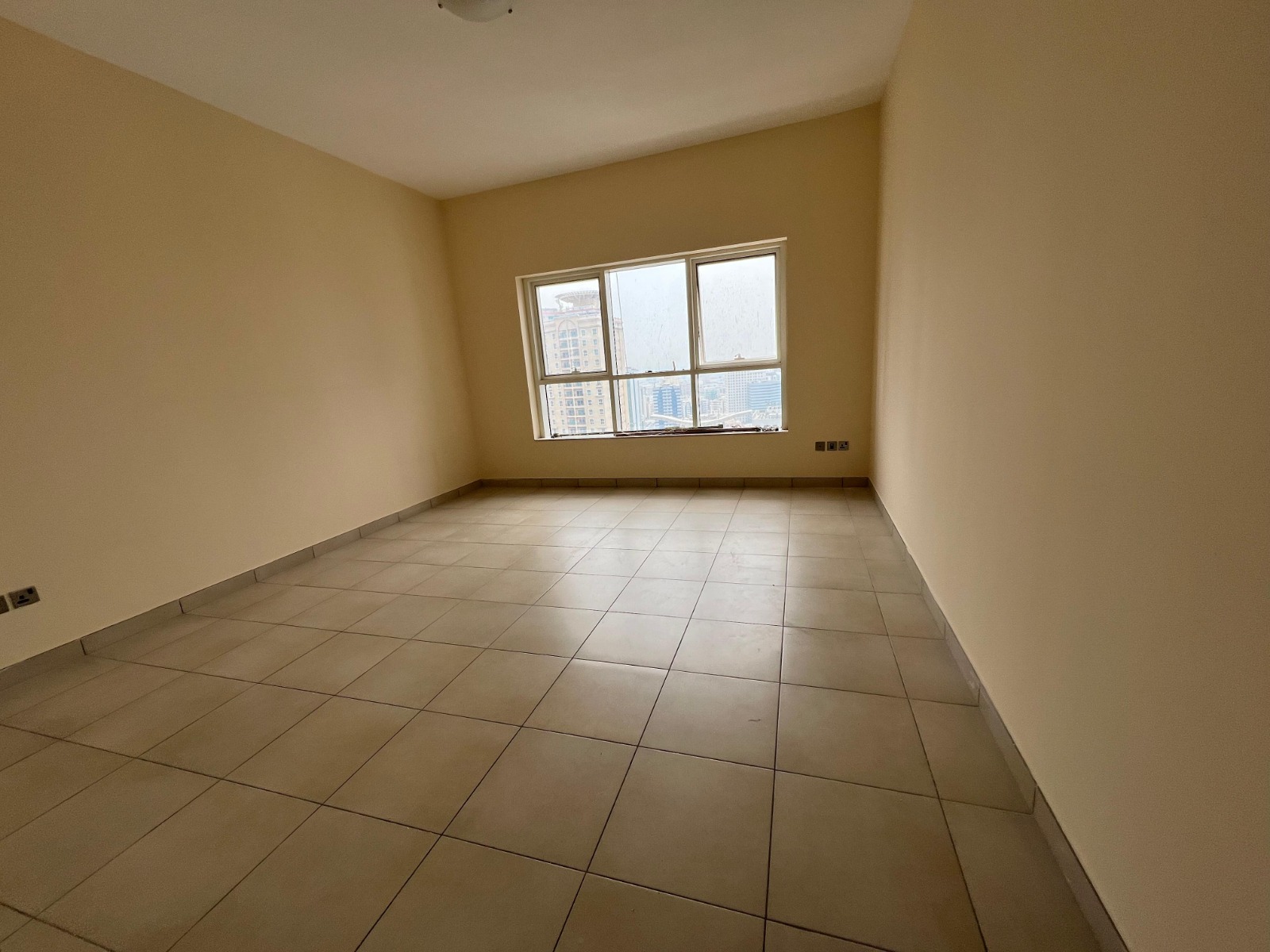 Two-bedroom apartment with living room in Al Khan, rear view, 2 parking spaces, gym, swimming pool, master maid’s room, annual rent, payable in 4