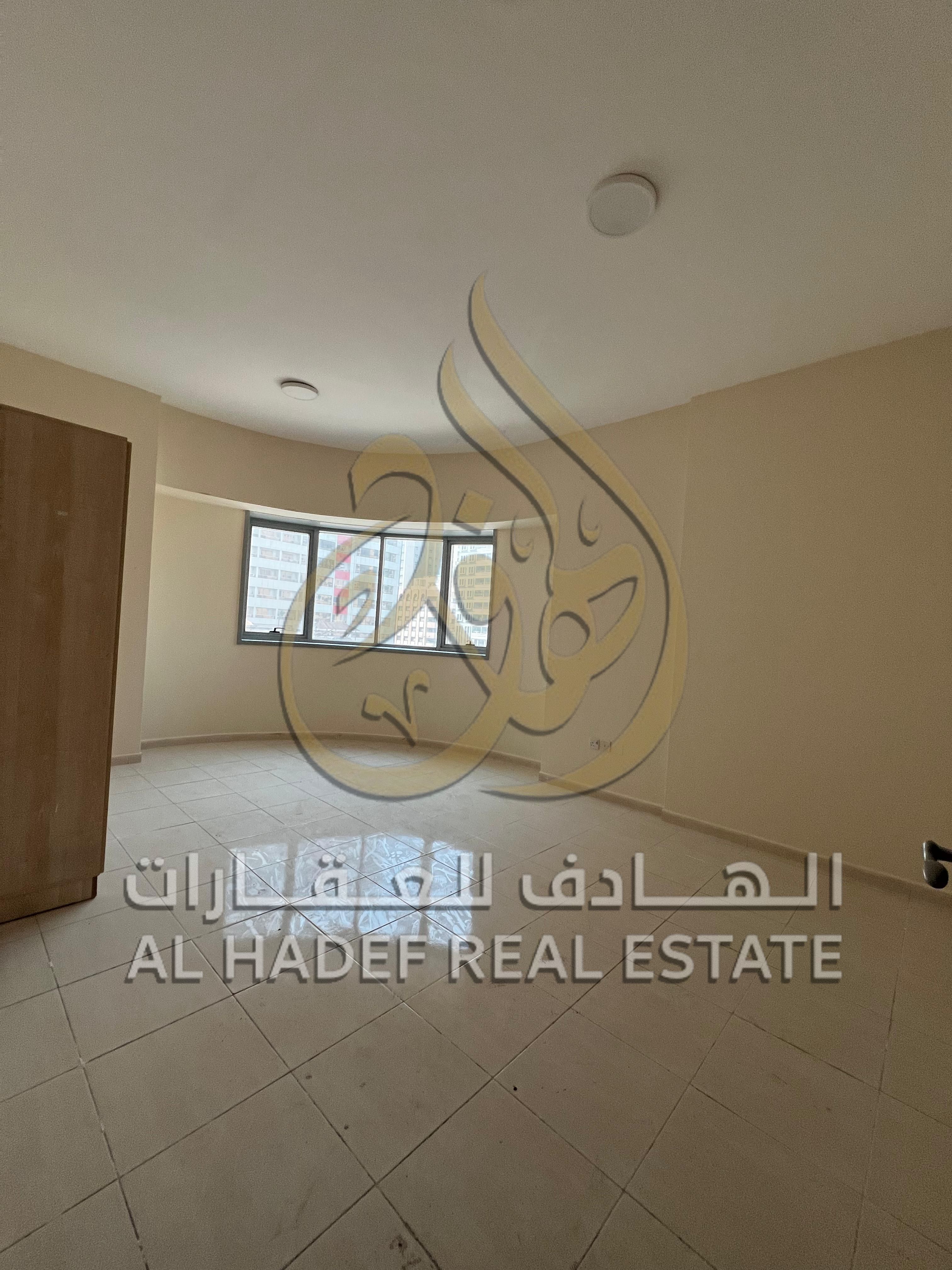 Apartment for rent in Al Majaz 2 – Two bedrooms, living room with balcony, 3 bathrooms, air conditioning included, and free parking.