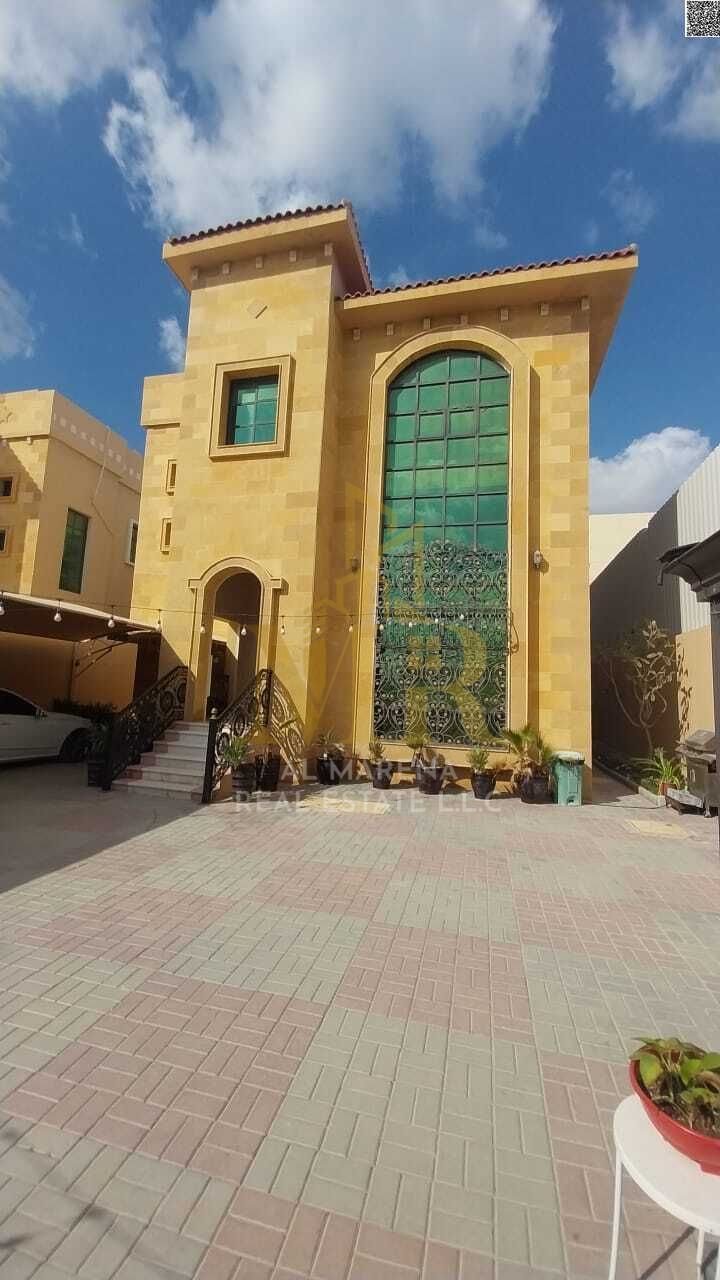 Villa for sale in Al Rawda 2, Ajman, price includes air conditioning, electricity, and water. Freehold ownership.