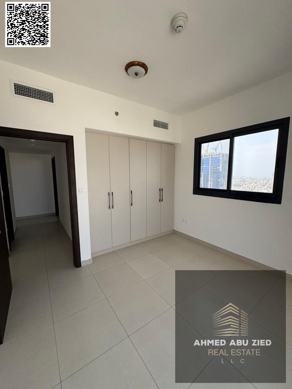 Two bedrooms and a living room, first occupancy, with free parking and one month free, in Al Nuaimiya 1, behind Emirates Markets on Al Ittihad Street.