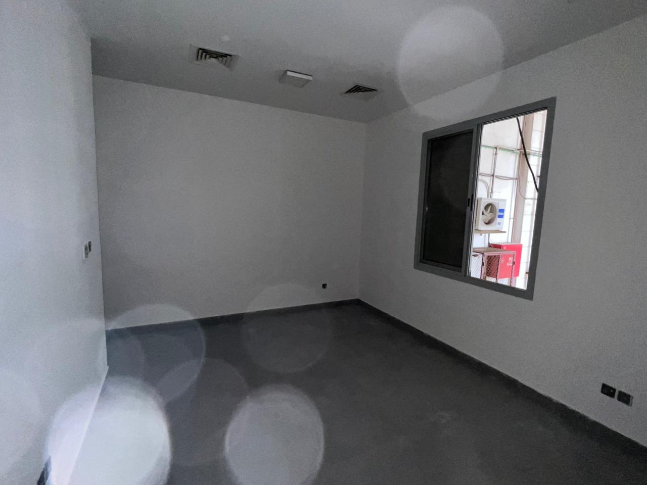 Studio for yearly rent in Al Rawda, ground floor, second tenant, separate kitchen, central AC, free maintenance, located behind Al Hamidiya Police Sta