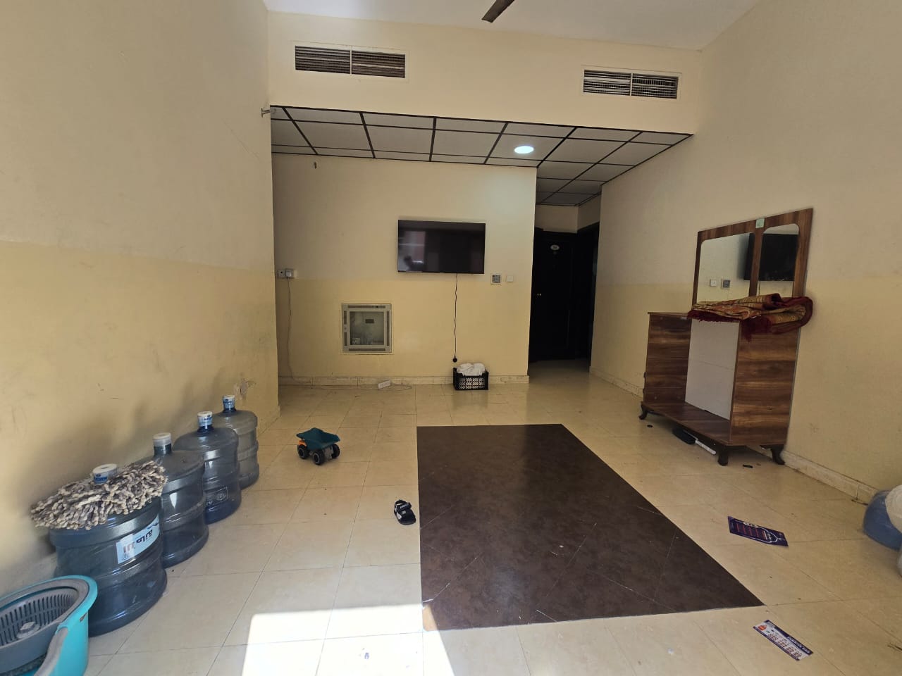 One-bedroom apartment with living room, two bathrooms, and balcony for annual rent in Al Jurf 2 behind Delta Center, central AC, maintenance by tenant