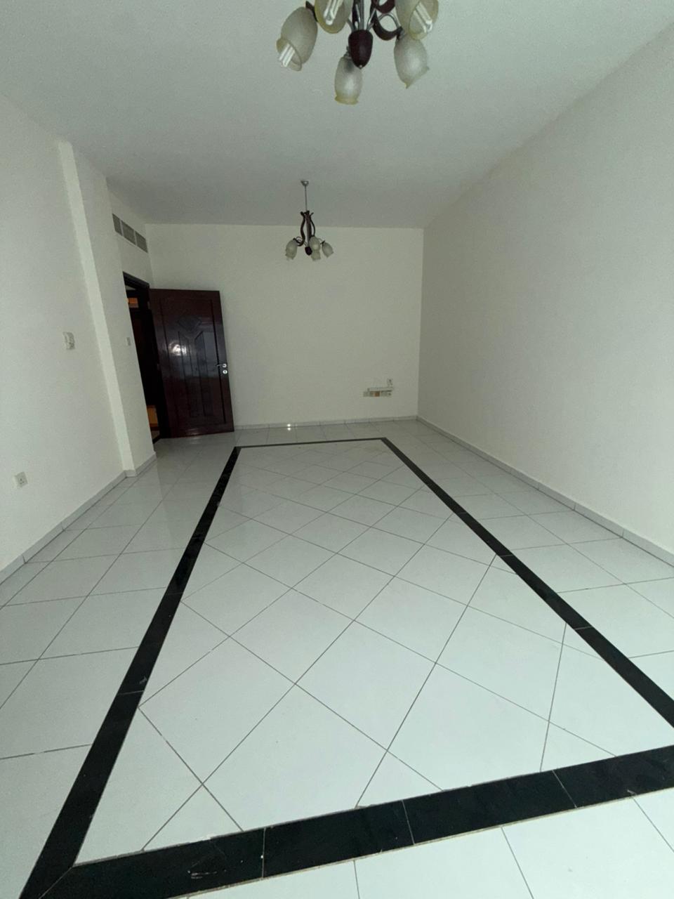 For rent in Al Qasba Corniche: spacious 2BR with separate hall, balcony, 2 bathrooms, prime location near services. Rent AED 43,000 yearly, 4 payments